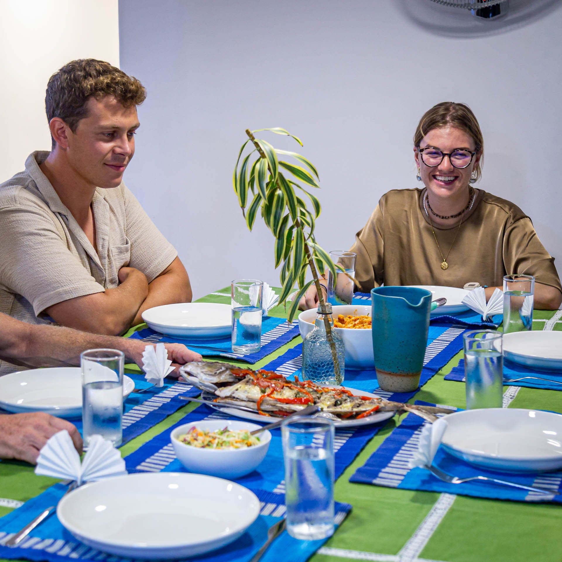 Guests sitting down to a lunch of freshly grilled fish on board NOAH